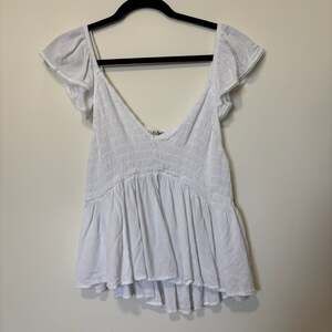 Wallflower white smocked babydoll top with flutter ruffle sleeves